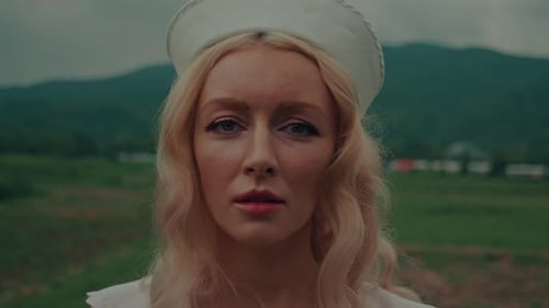 Blonde Woman in Bonnet in Rural Setting