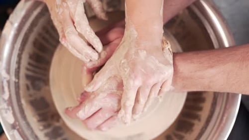 Pottery Wheel with Hands Shaping Clay Close Up