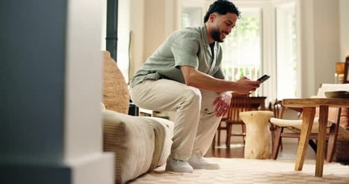 Man Using Smartphone Sitting on Couch at Home