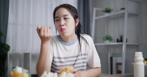 Woman Enjoys Dessert at Home at Table