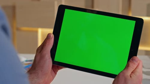 Company Worker Looking Greenscreen Tablet Browsing Video in Office Close Up