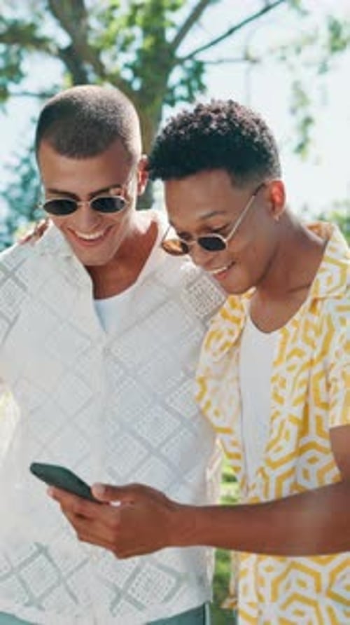 Happy, walking and friends with phone in park for social media, funny message