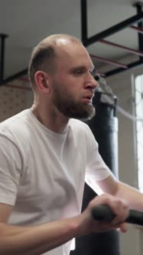 Man Using Rowing Machine for Intense Workout
