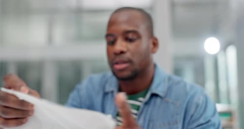 Adult Wipes Nose with Tissue at Workplace