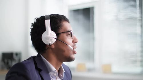 Man Talking on Headset at Work in Office