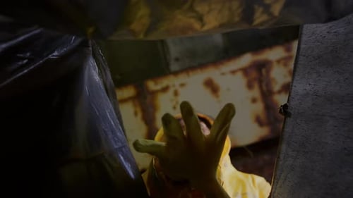 Bottom View Low Angle a Man and a Woman Put Waste in a Garbage Bag