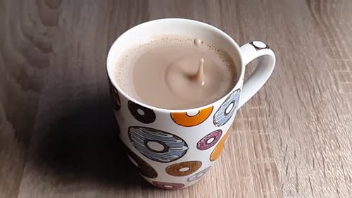 Coffee Drop Creates Crown Splash in Donut Mug