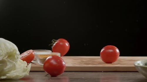 Delicious Tomatoes Fall Onto the Cutting Board in the Restaurant Kitchen