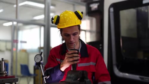 Engineer Measuring Part with Calipers in Factory Setting