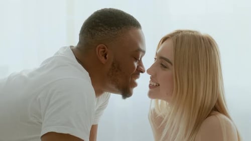 Happy Couple Affectionately Kissing Indoors