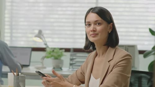 Portrait of Businesswoman with Smartphone at Office Workplace