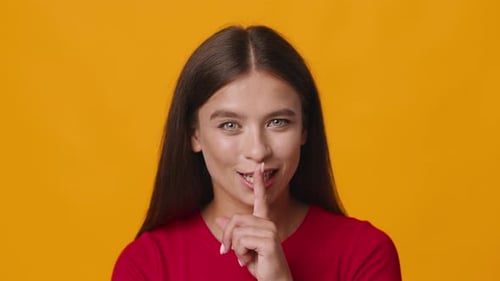 Woman Smiles and Motions for Silence