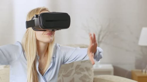 Woman Using Virtual Reality Headset at Home