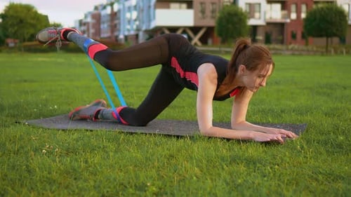 Woman Doing Leg Exercises in Urban Park