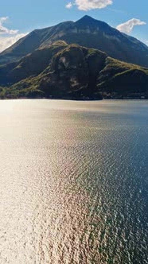 Aerial drone view of the Alps with a blue sky near Lake Como, Italy. Vertical