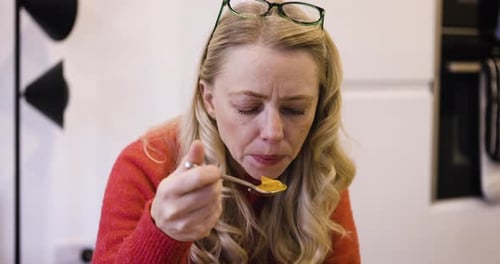 Woman with blonde hair eating food