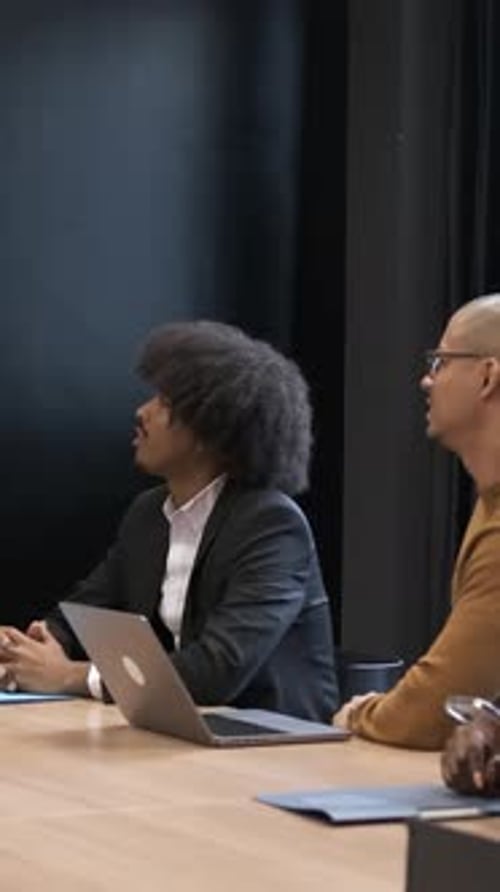 Diverse Colleagues Applaud Success in Bright Meeting Room