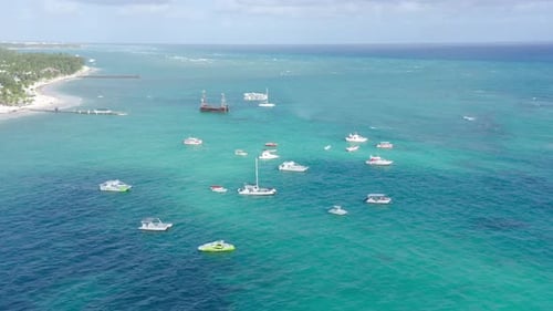 Boats moored at Los Corales Beach Village, Punta Cana in Dominican Republic. Aerial panoramic view