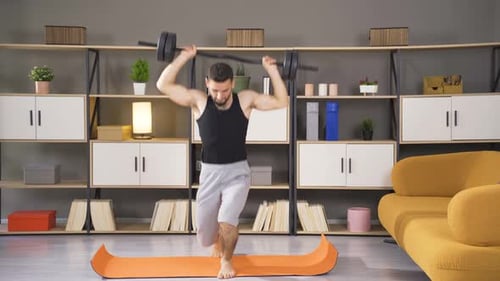 Man Doing Lunges with Barbell at Home