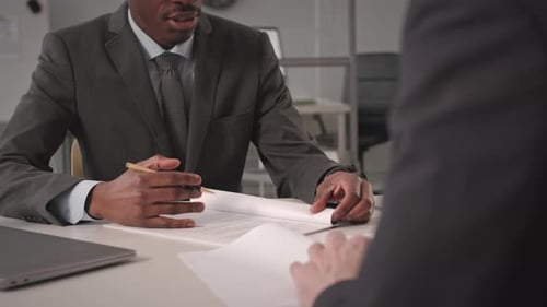 Businessmen Signing Contract and Shaking Hands in Office