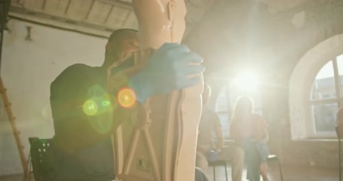 CPR Demonstration on Medical Dummy in Classroom