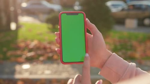 NEW YORK April 5 2019 Slow Motion Hands Woman Holding Use Vertical Phone with Green Screen at Sunny