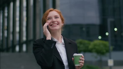 Smiling Young Woman Talking on Phone in City