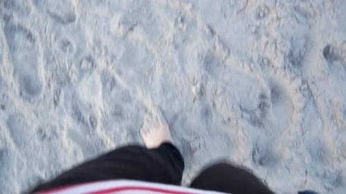 Bare Feet Walking on Sandy Beach POV