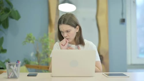 Woman Coughing While Working at Computer