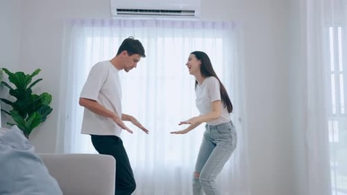 Couple Dancing Together and Laughing in Living Room