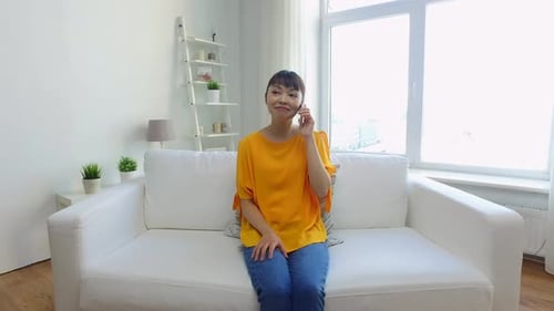 Woman in bright top talking on her phone