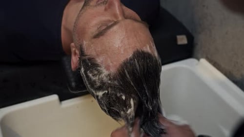Man Getting Hair Washed at Salon