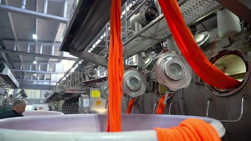 Textile Factory: Dyeing Orange Fabric in Industrial Machine