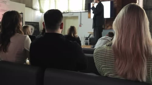 Conference Audience Listening to Speaker in Urban Setting
