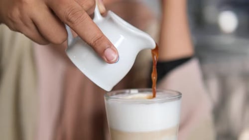 Pouring Espresso into Foamy Latte