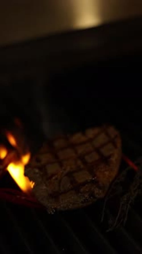 Chef cooking meat in a restaurant