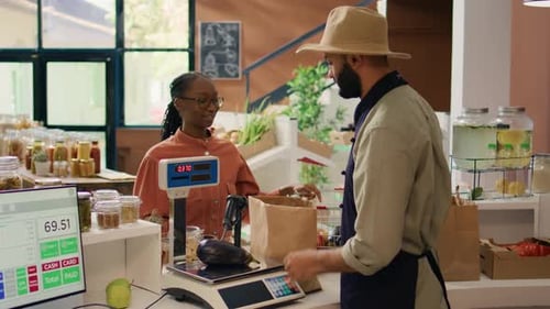 Produce Clerk Weighing Vegetables for Customer at Market