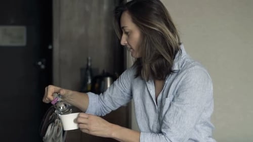 Attractive Businesswoman Pouring and Drinking Coffee During Breakfast in Hotel Adult