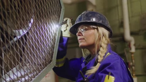 Mature woman inspecting outdated boiler room in Canada slow motion