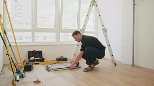 Man Cutting Tiles for Home Improvement Project