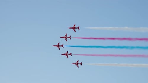 Aerobatic Planes Skywriting with Colored Smoke Trails Formation