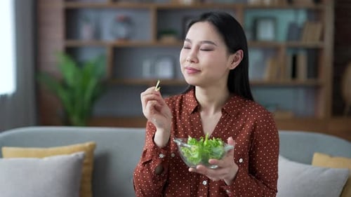 Woman Eats Healthy Green Salad at Home