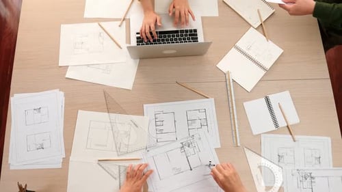 Architect and engineer working with blueprint and laptop. Close up. Delineation.