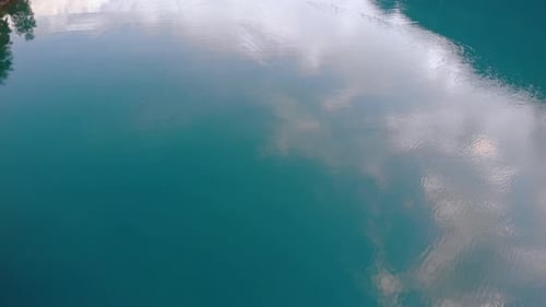 Glacier lake tilt up to reveal scenic panorama of Alp mountains in Switzerland