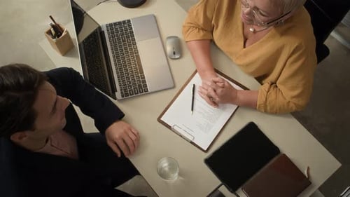 Business Colleagues Meeting at Desk with Laptop