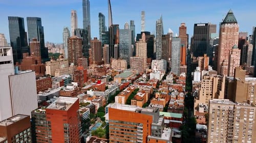 Sunny cityscape of New York from aerial view. Drone footage approaching stunning skyscrapers.