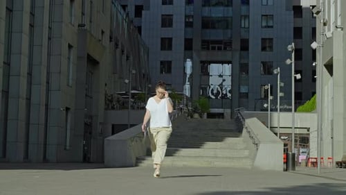 Lady Steps Out of Business Complex Heading Home After a Productive Workday
