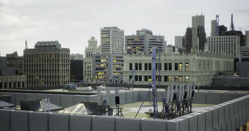 City Skyline During Twilight with Antennas and Rooftops Visible