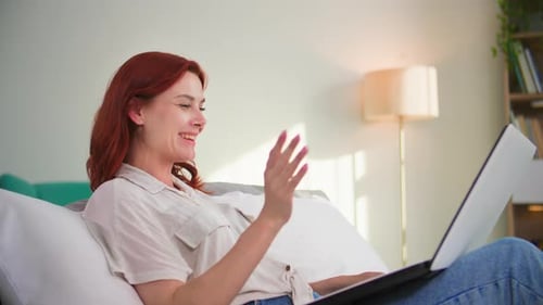 Woman Using Laptop for Video Call at Home