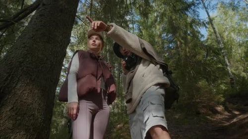 Hiking Couple Taking Photos of Forest Setting during Summer Trip